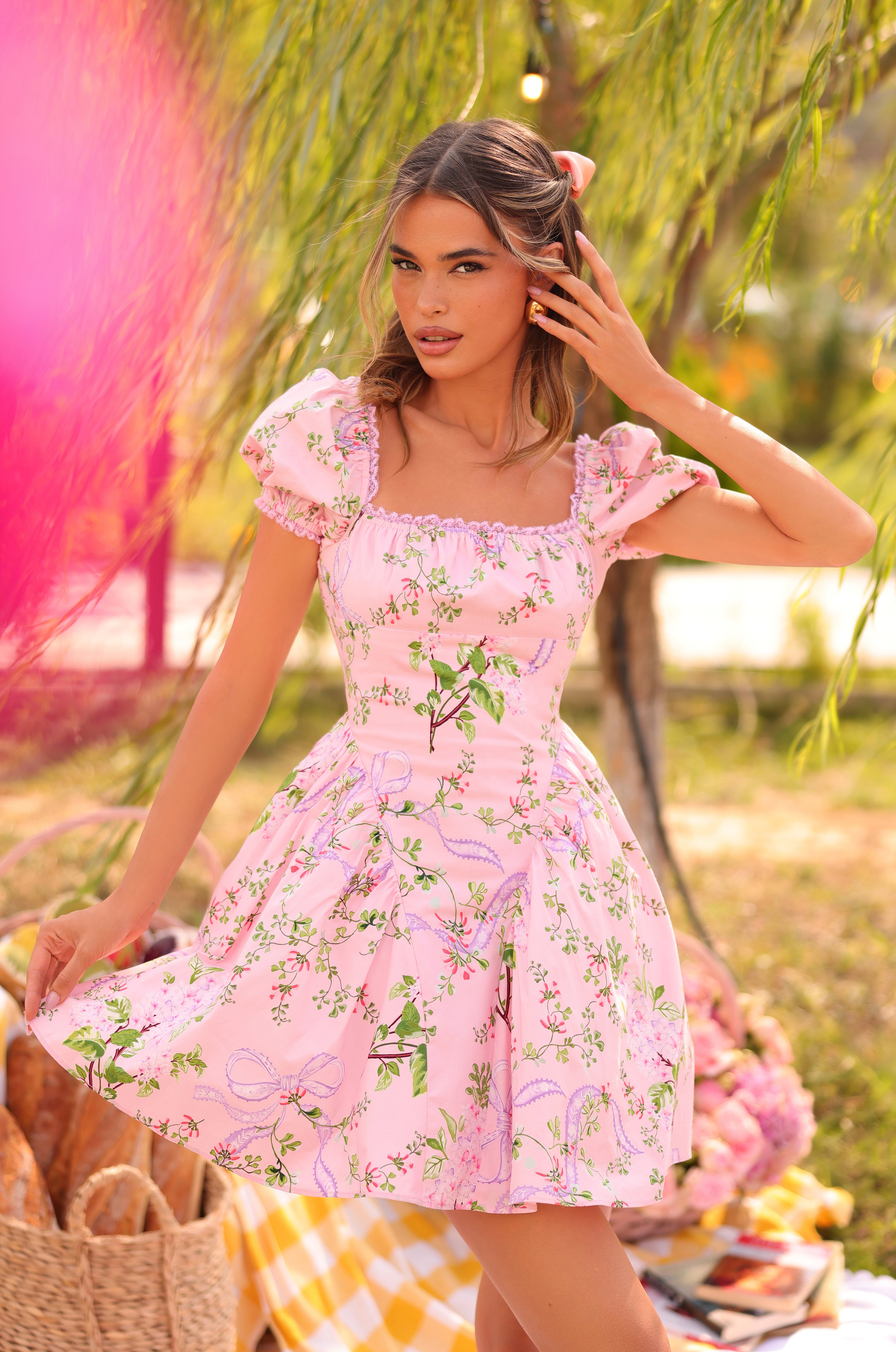 Pink floral puff-sleeve mini dress on model outdoors