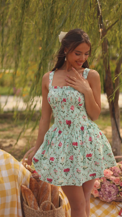 Mint green floral corset mini dress with straps on model outdoors
