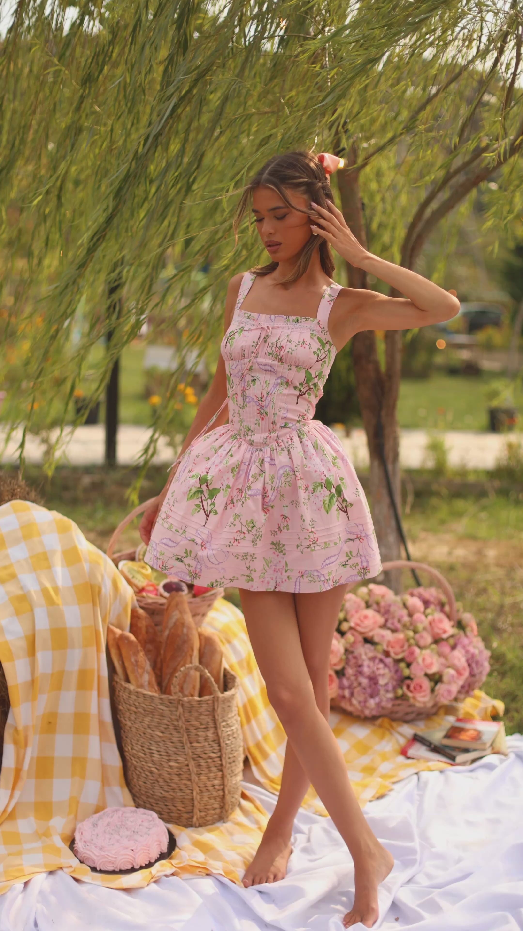 Pink floral corset mini dress with straps on model outdoors